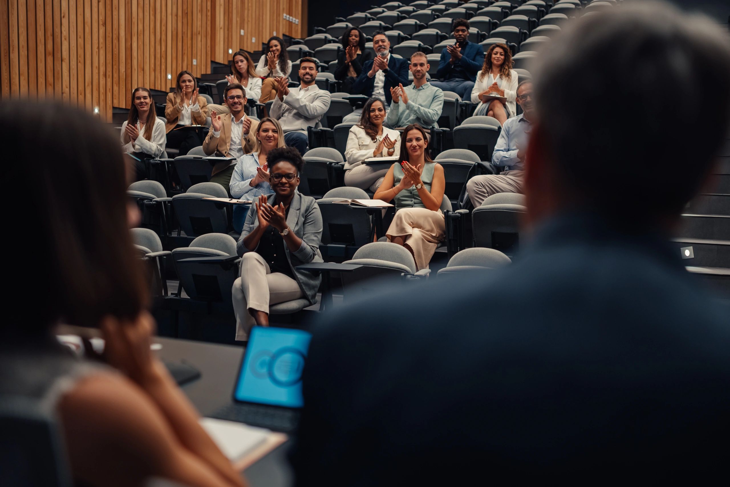 Group of professionals applauding during a public media association event